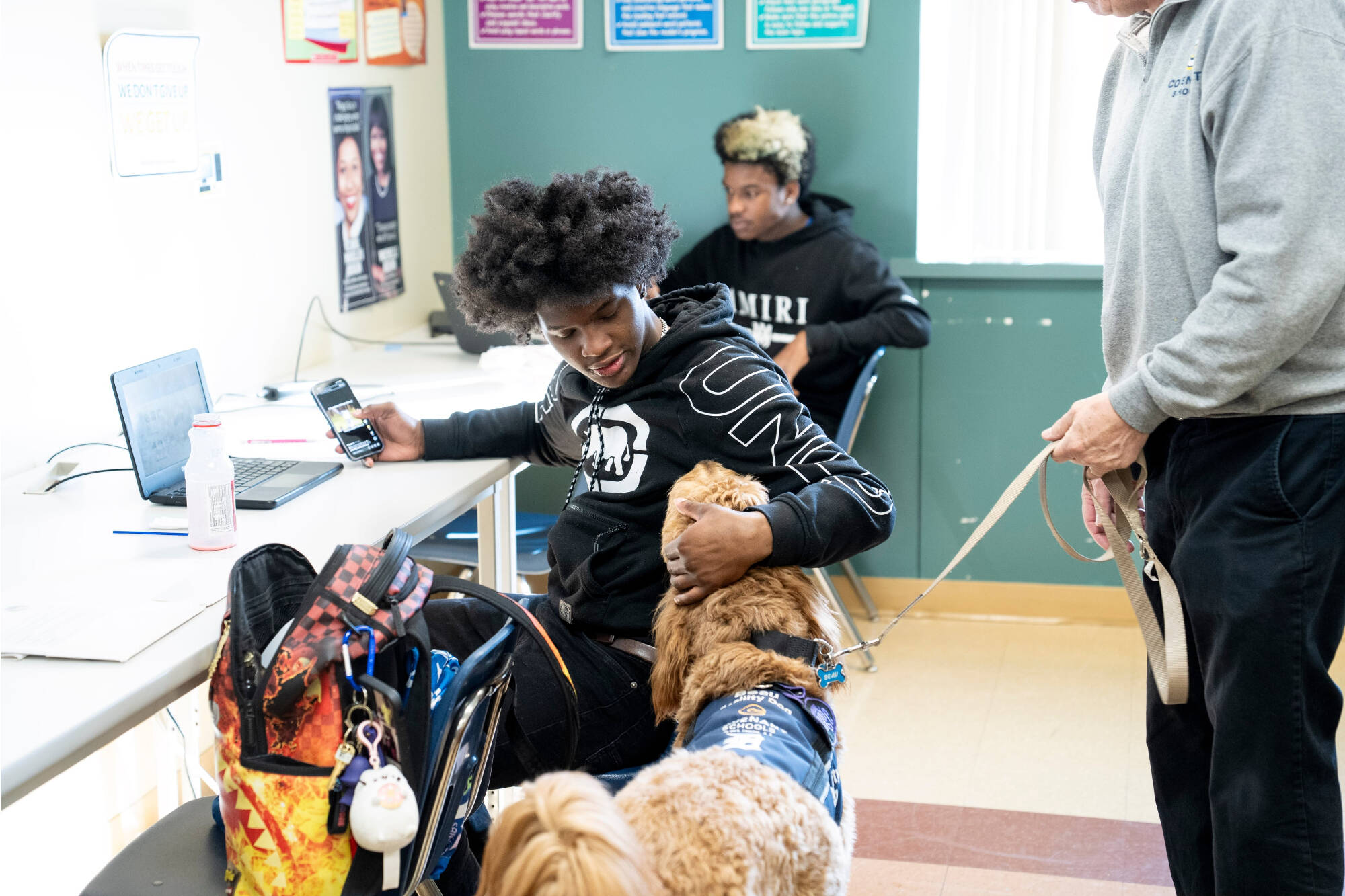 student hugging Beau the dog